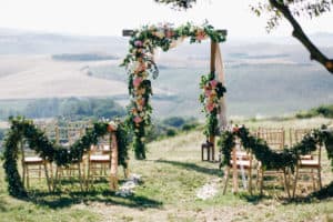 Wedding ceremony with flower arch on the mountain