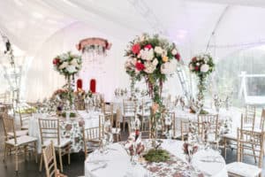 Tall flower centerpieces in a tent