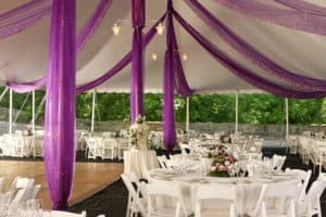 Purple drape inside wedding tent