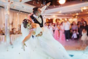 Bride and groom dancing under confetti