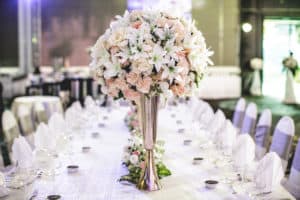 Large floral arrangement with lilies on wedding table