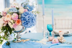 Beautiful floral arrangement on bride and grooms table with pink and blue flowers