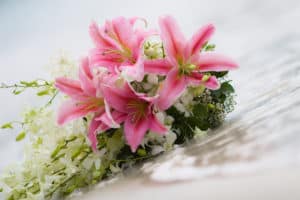 Wedding bouquet with pink lilies at the sea
