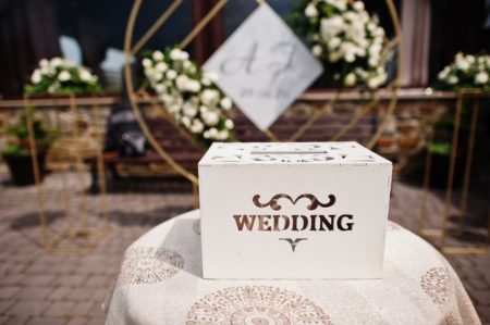 Wooden wedding box for money in table.