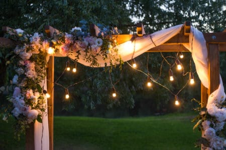 Beautiful place made with wooden square and floral decorations for outside wedding ceremony in wood.