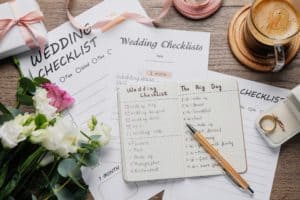 Flat lay composition with Wedding Checklists on wooden table
