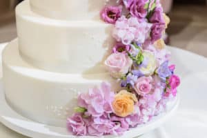 Wedding cake with purple cascading flowers