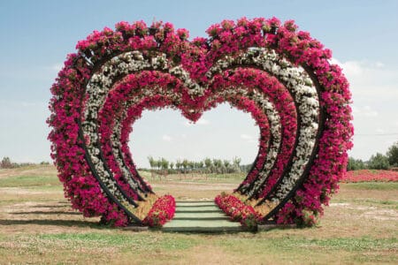 Large decorative wedding arches made in form of heart of flowers love in field for visiting wedding ceremony