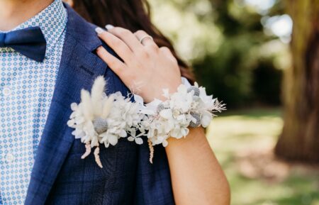 Blue suit and matching white corsage and boutonniere 