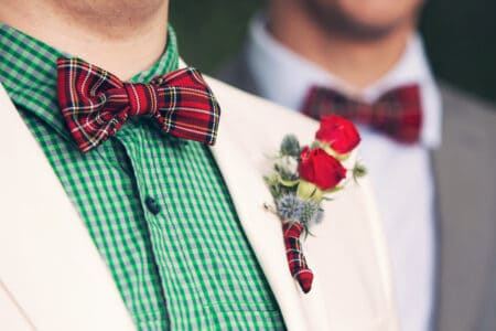 festive Christmas bow tie and red rose boutonniere
