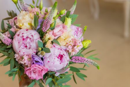 Rich bunch of pink peonies and lilac eustoma roses flowers, green leaf . Fresh spring bouquet. Holodays, gift.Arrangement of Beautiful blossoming flowers.wedding bouquet