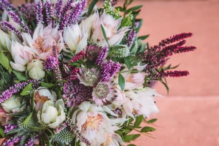 Beautiful autumn, wedding bouquet made out of a sortiment of sessional flowers, such as Calluna Vulgaris, Astrantia, Eryngium and white blushing bride Protea